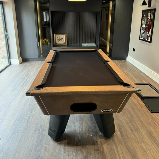 Pool table in a room with wooden flooring and a dark wall.