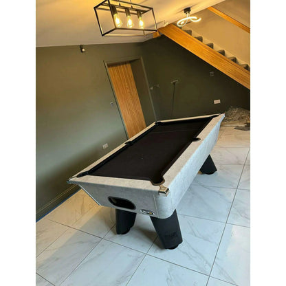 Pool table in a room with a staircase and light fixture.