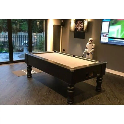 A dark wood pool table with a light beige felt surface in a modern home entertainment room, featuring a dartboard on the wall and a Star Wars Stormtrooper figurine.