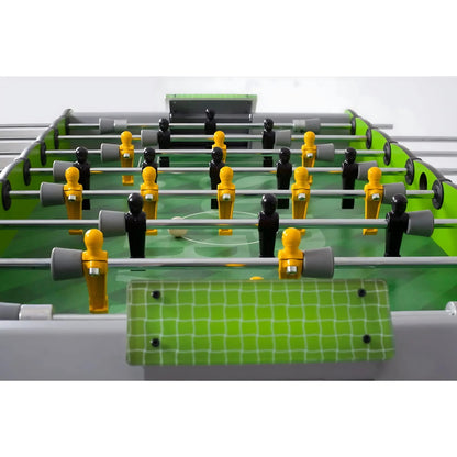 Close-up of a foosball table with green playing surface and red accents.