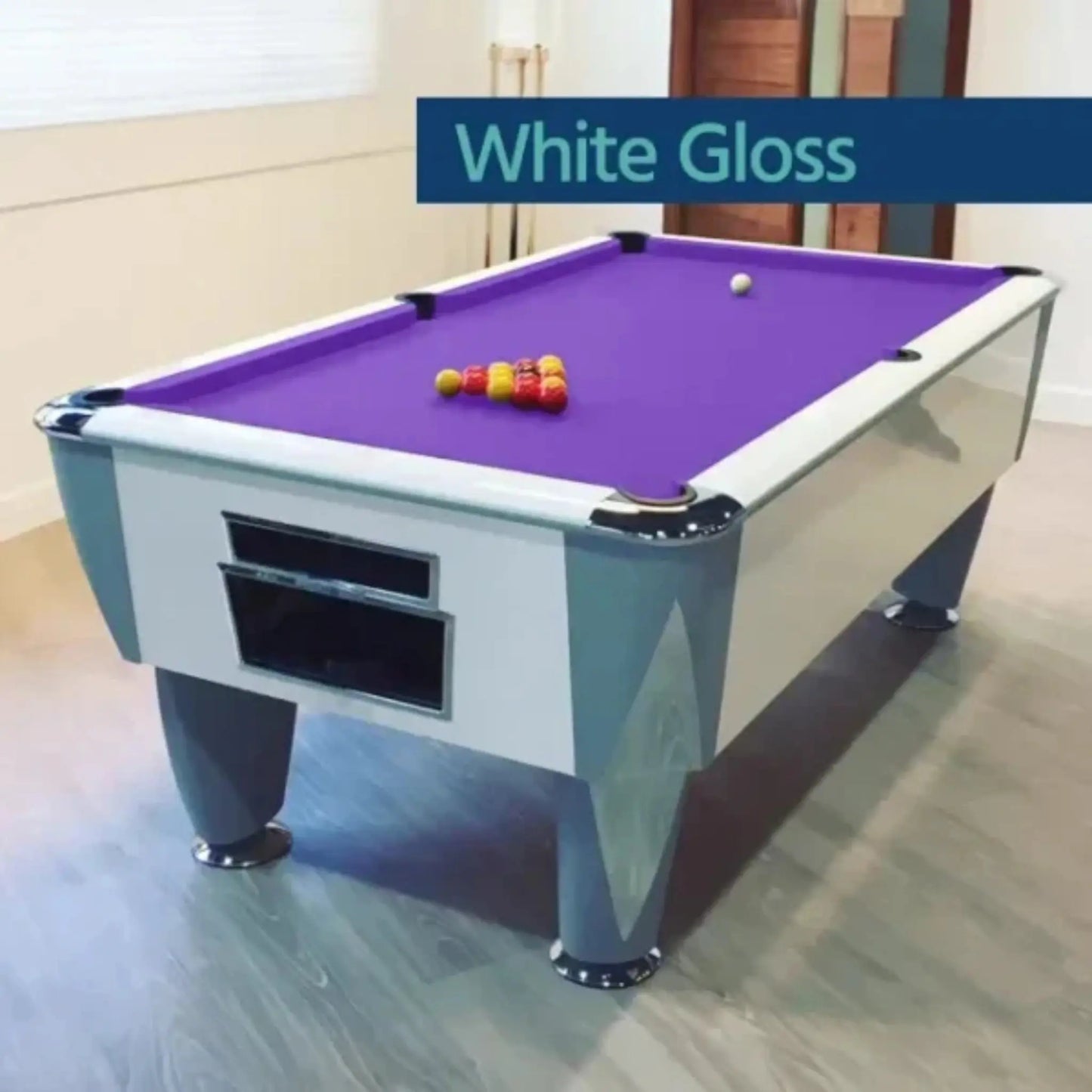 Pool table with purple felt and billiard balls on a wooden floor.